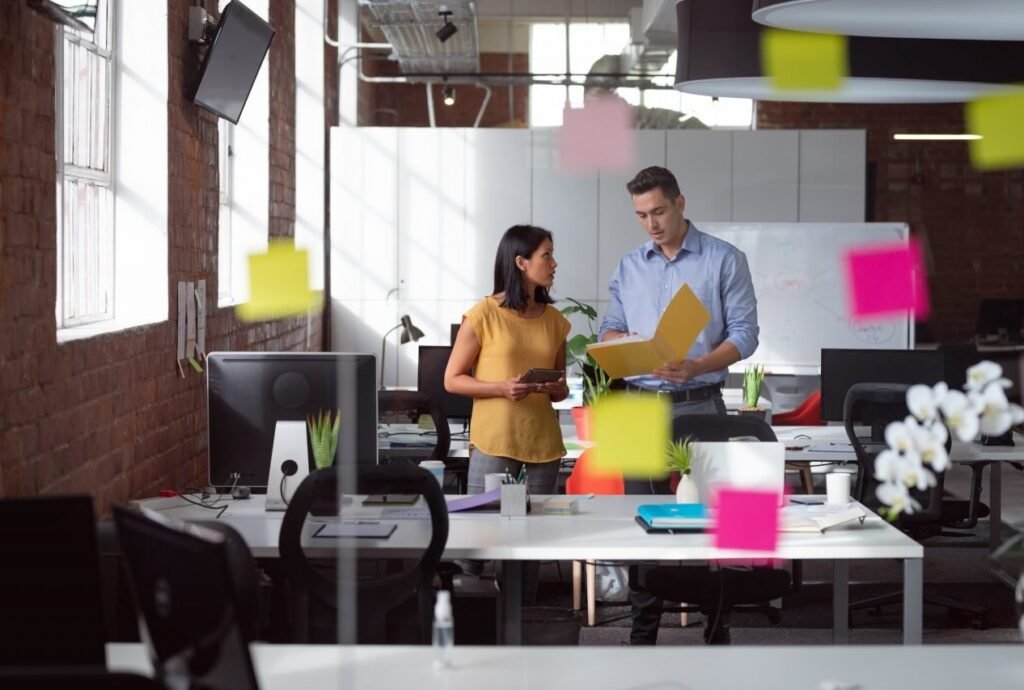 caucasian-male-and-female-colleague-discuss-tablet-and-file-view-through-glass-wall-and-memo-notes.jpg